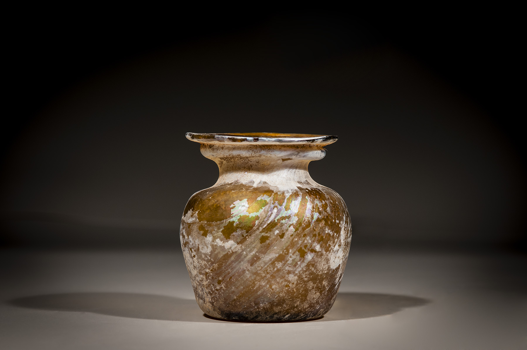A Roman Amber Glass Jar with Diagonal Ribbing - Image 2